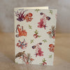 Five small gift cards with colorful undersea-themed illustrations, including crabs, seahorses, and sea plants, arranged on a textured beige surface. Printed on textured ivory paper. 