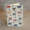 Five small gift cards with colorful undersea-themed illustrations, including crabs, seahorses, and sea plants, arranged on a textured beige surface. Printed on textured ivory paper. 