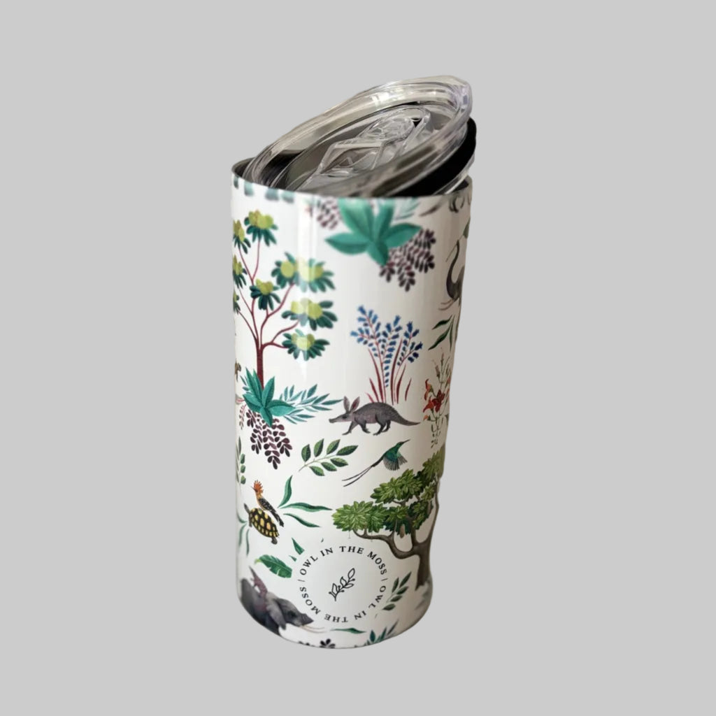 Tumbler with nature-themed design on a plain surface